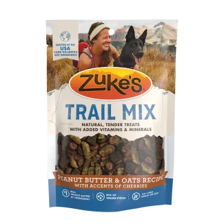 Front of a 6 ounce package of Zukes Trail Mix dog treats with peanut butter, oats, accents of cherries
